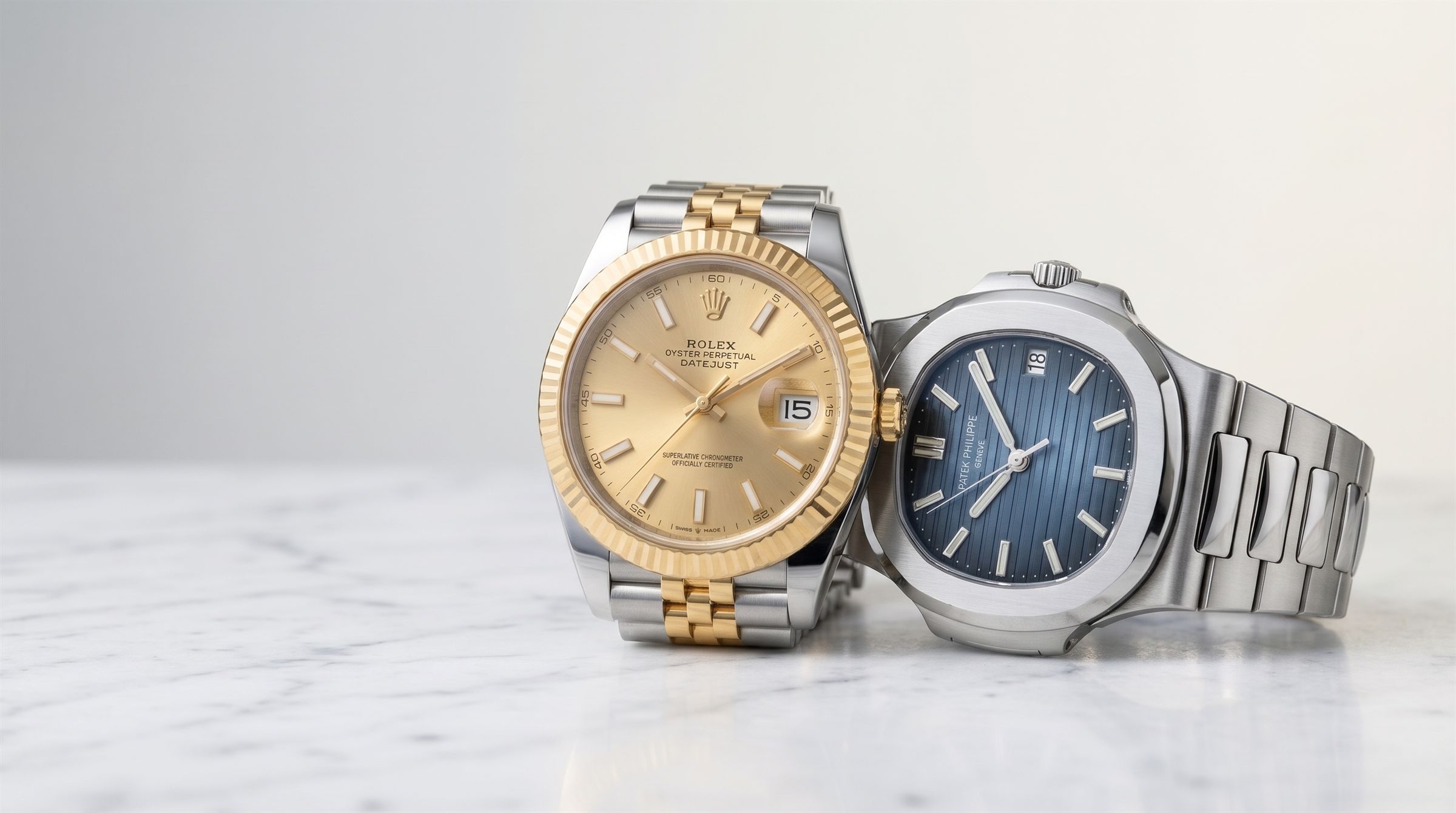 Two-tone gold and steel luxury watch on a light background